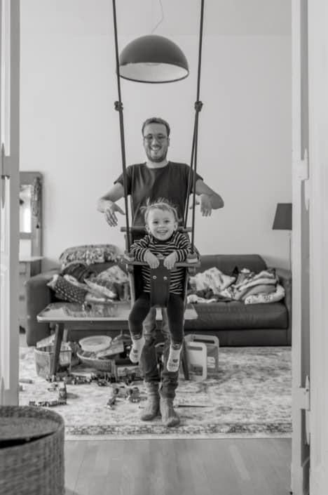 Familienreportage. Kind schaukelt zuhause Familienreportage. Kind schaukelt zuhause